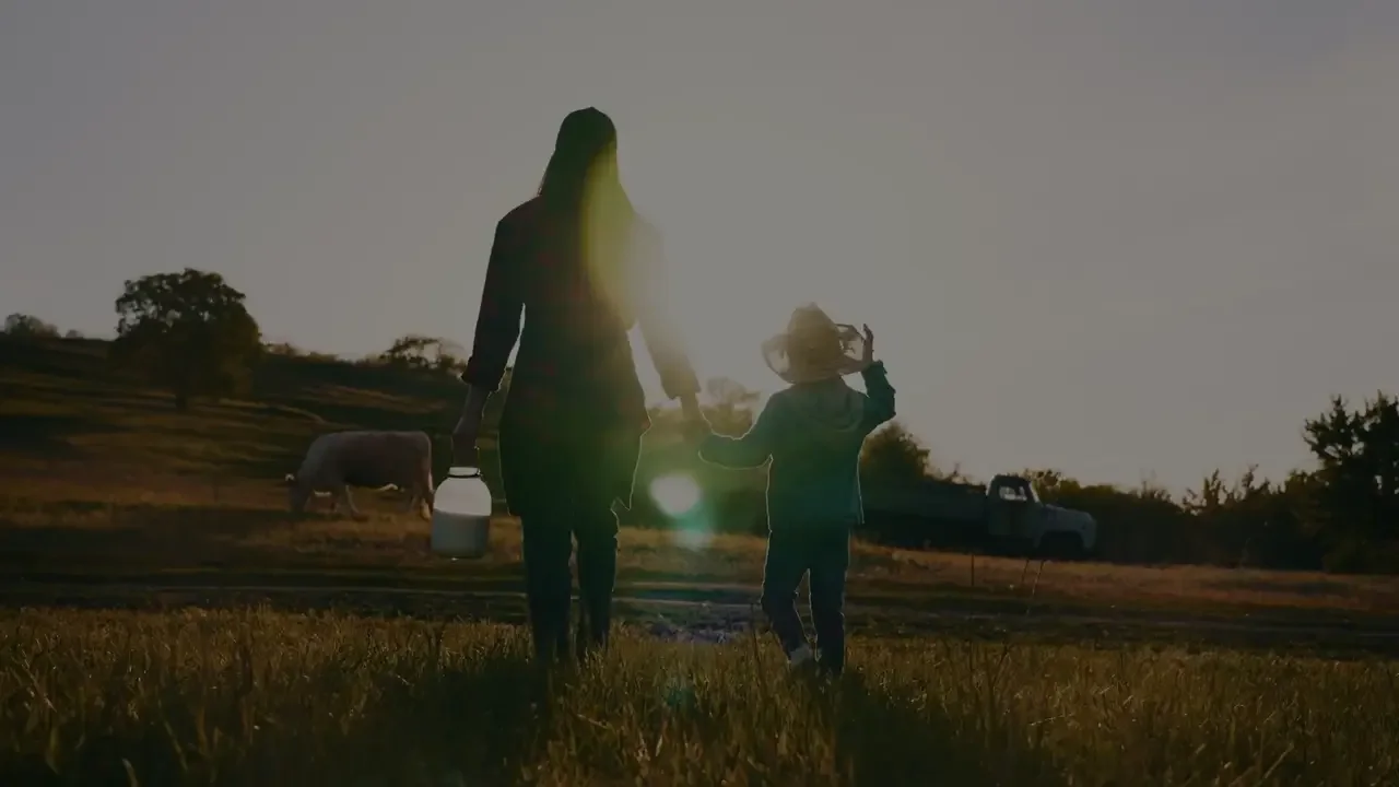 sHEALed: a mother and child in a field at dusk