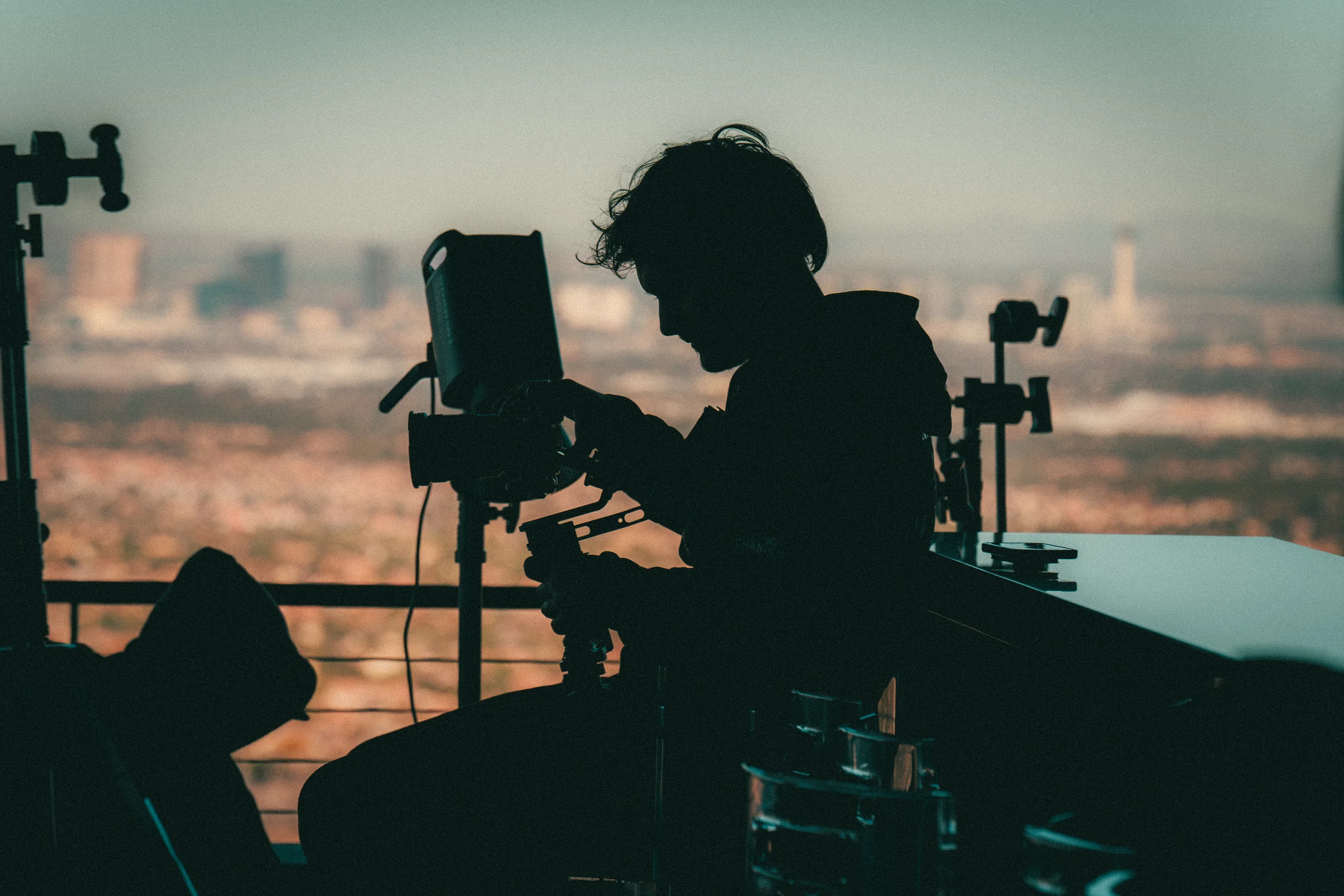 Operator. In silhouette above the city, on the sHEALed set