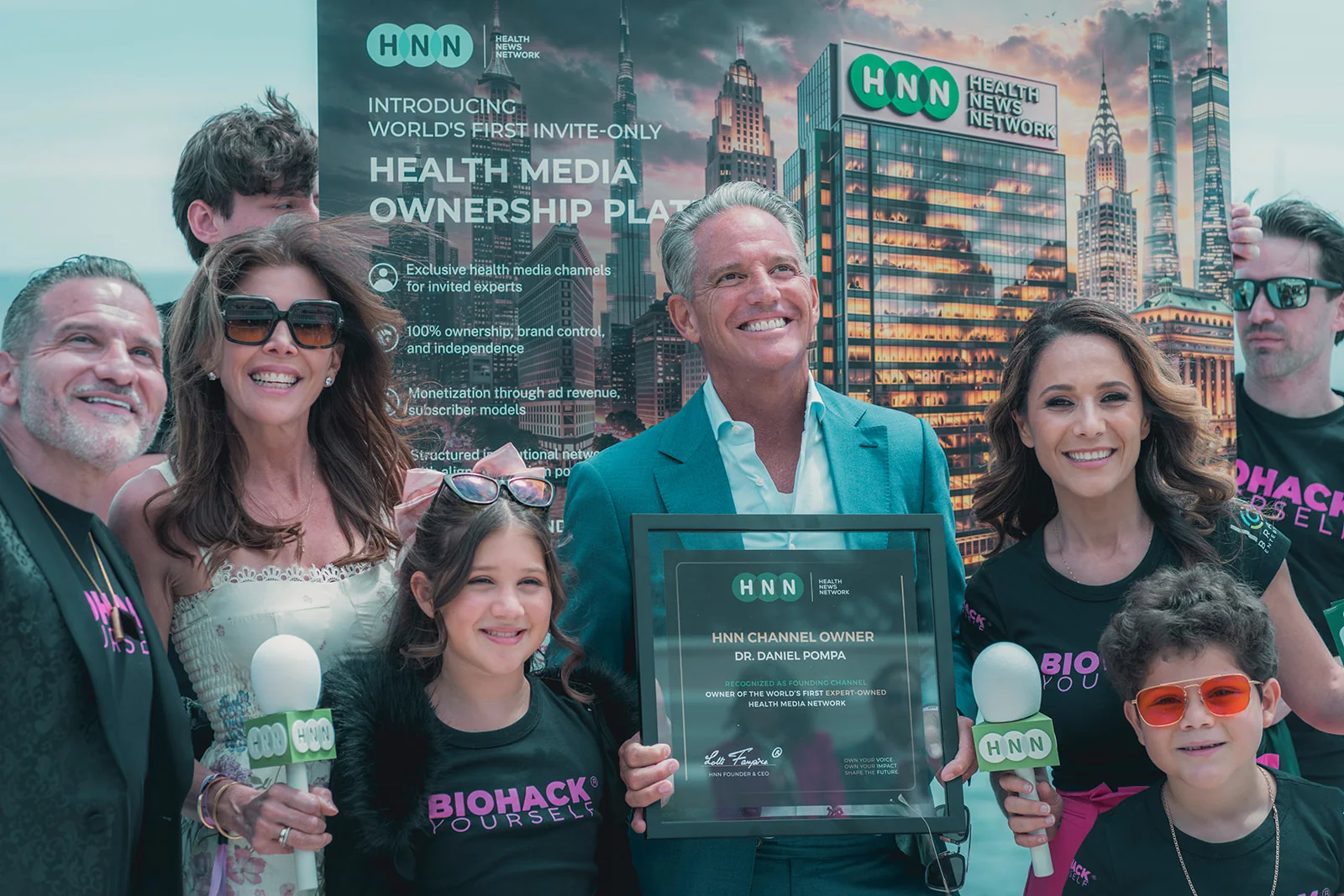 Dr. Daniel Pompa with his HNN Channel Owner plaque, the Lolli family and HNN microphones, at the sHEALed premiere